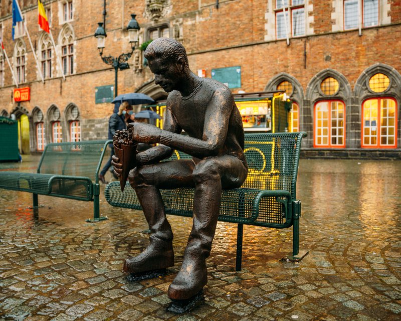 frites eater statue in Bruges Belgium
